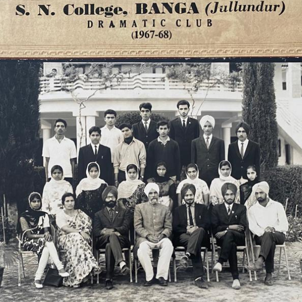 Black and white group photo of a male and female Indian college students, some sitting some standing